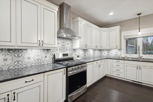 kitchen featuring white cabinetry, sink, dark wood-type flooring, wall chimney range hood, and stainless steel range with gas cooktop