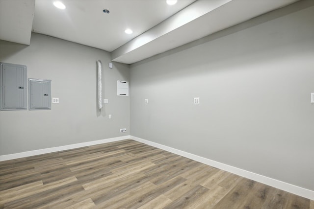 spare room with hardwood / wood-style floors and electric panel