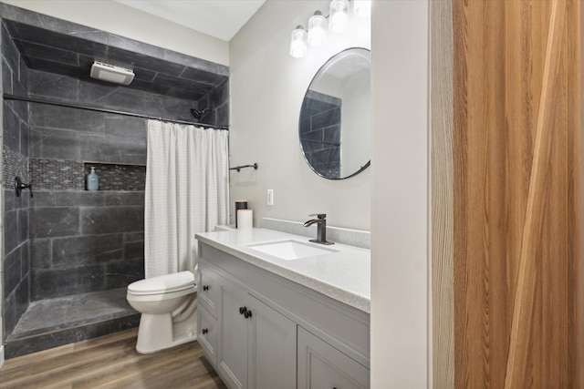 bathroom featuring curtained shower, hardwood / wood-style floors, vanity, and toilet