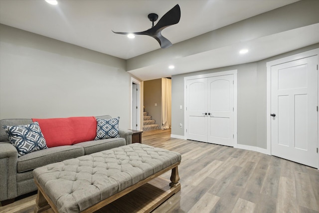 living room featuring ceiling fan and wood-type flooring