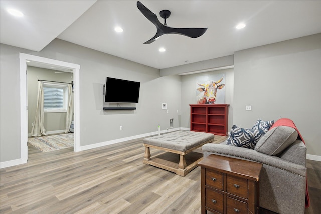 living room featuring ceiling fan and light wood-type flooring