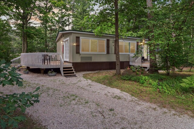 8529 N Blair Dr, Bitely, MI 49309 - view of front facade featuring a wooden deck