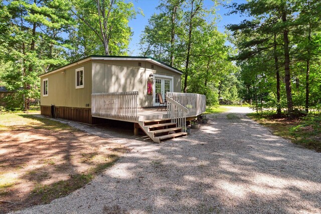 8529 N Blair Dr, Bitely, MI 49309 - view of front of house with a wooden deck and french doors
