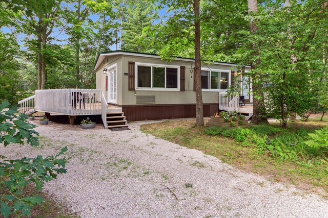 8529 N Blair Dr, Bitely, MI 49309 - manufactured / mobile home featuring a wooden deck