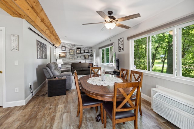 dining space with hardwood / wood-style floors, ceiling fan, a wall mounted air conditioner, and vaulted ceiling