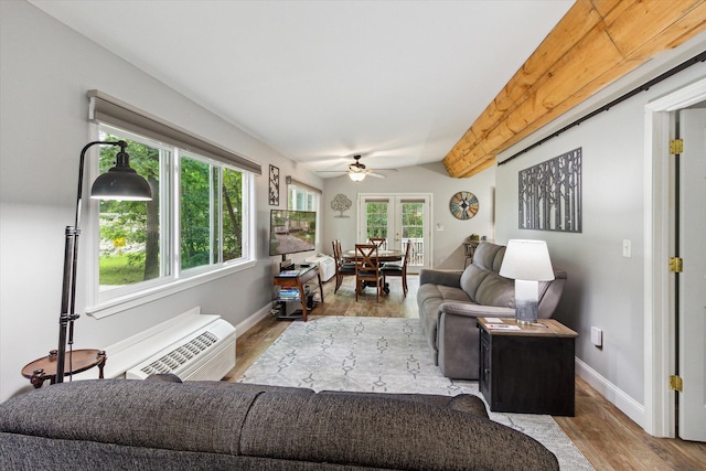 living room featuring french doors, vaulted ceiling with beams, ceiling fan, a wall mounted AC, and light hardwood / wood-style floors