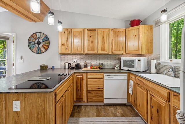 8529 N Blair Dr, Bitely, MI 49309 - kitchen featuring white appliances, a sink, a peninsula, vaulted ceiling, and healthy amount of natural light