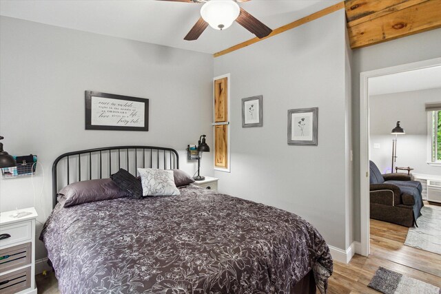 8529 N Blair Dr, Bitely, MI 49309 - bedroom with wood finished floors, a ceiling fan, and baseboards