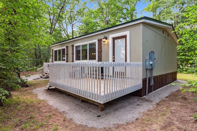 back of property with a wooden deck