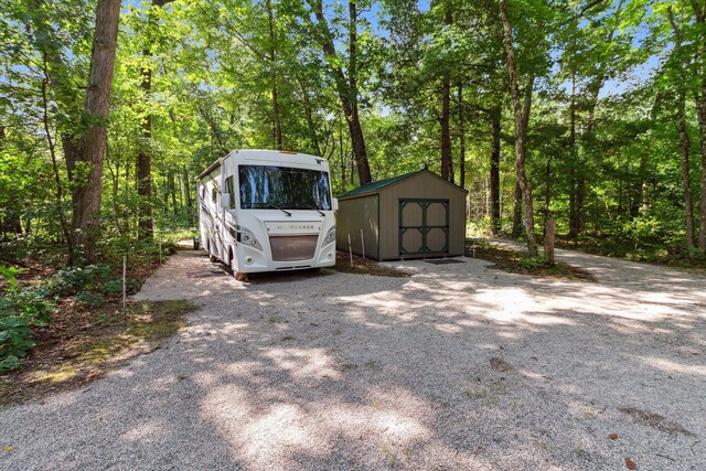 8529 N Blair Dr, Bitely, MI 49309 - view of vehicle parking featuring a storage shed