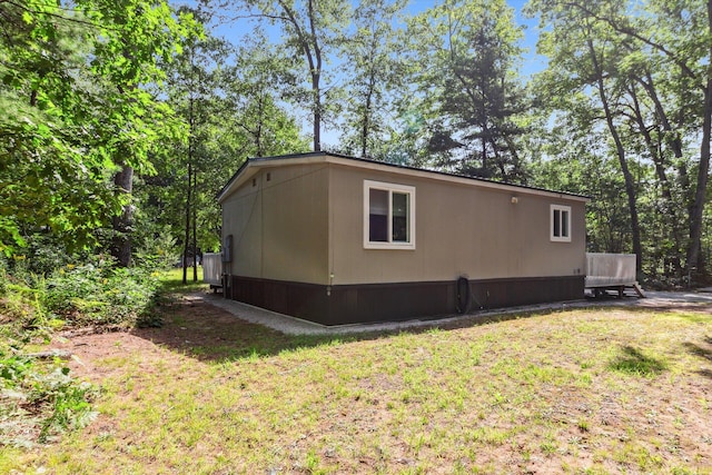 view of side of property with a yard