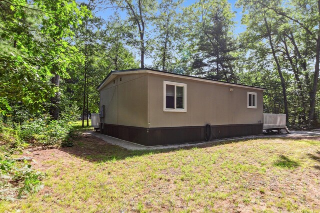 8529 N Blair Dr, Bitely, MI 49309 - view of property exterior featuring a lawn