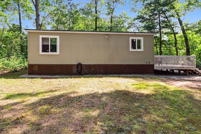 view of home's exterior featuring a yard and a deck