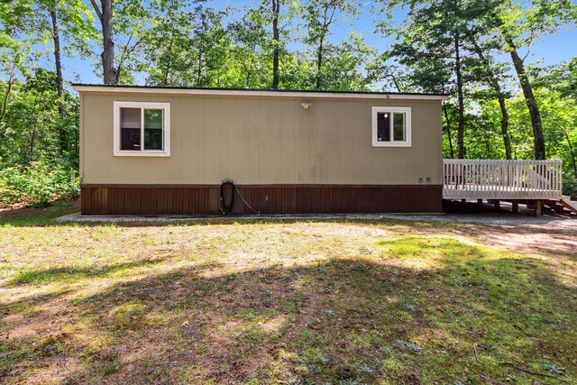 8529 N Blair Dr, Bitely, MI 49309 - view of home's exterior with a deck and a yard