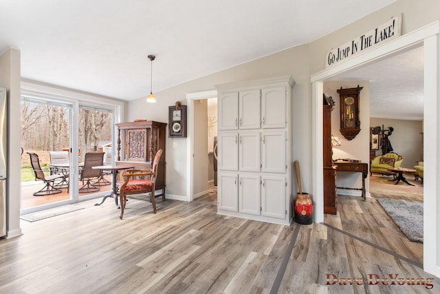 sitting room with light hardwood / wood-style flooring and lofted ceiling