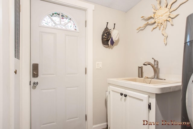 interior space featuring sink and a textured ceiling