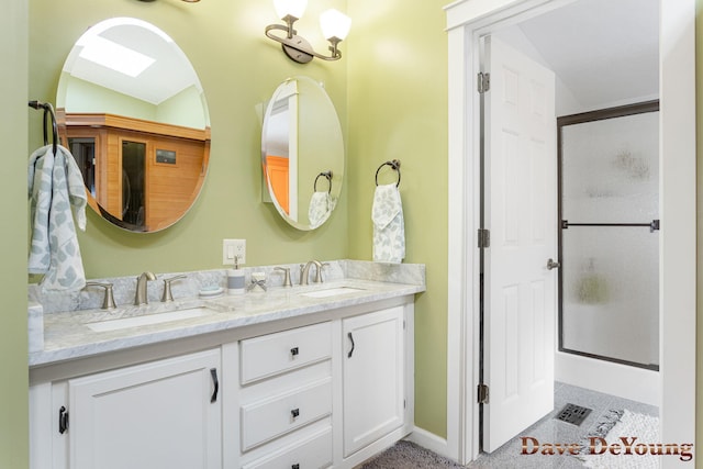 bathroom with a shower with shower door, lofted ceiling, and vanity