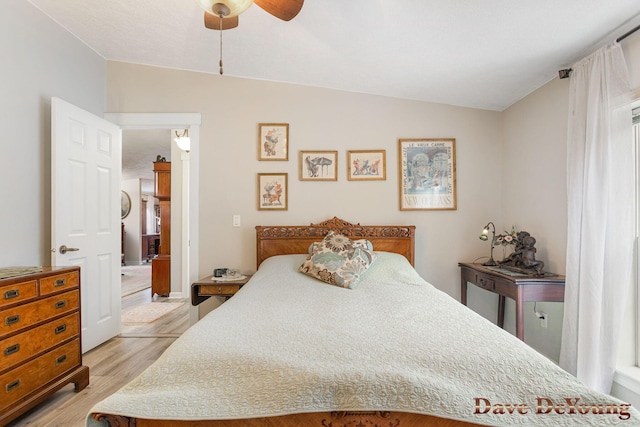 bedroom featuring ceiling fan, light wood-type flooring, and vaulted ceiling