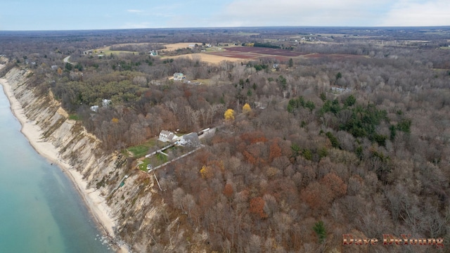 birds eye view of property featuring a water view and a beach view