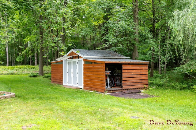 view of outdoor structure featuring a lawn