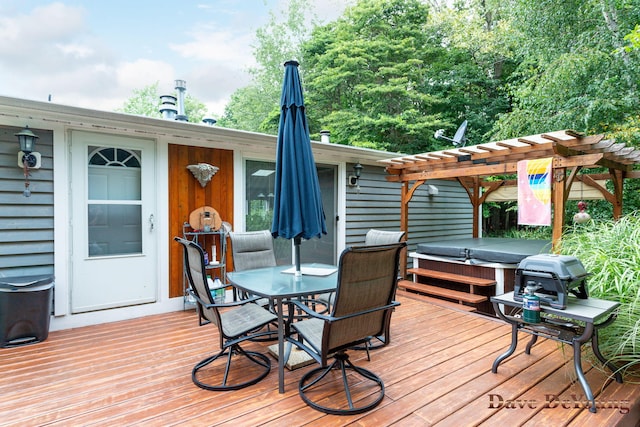 deck featuring a pergola and a hot tub