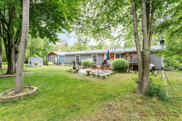 back of house with a lawn and a patio