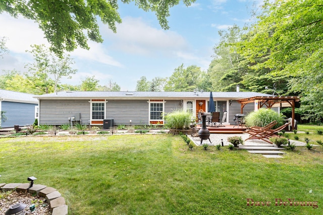 back of property featuring a pergola, a deck, cooling unit, and a lawn