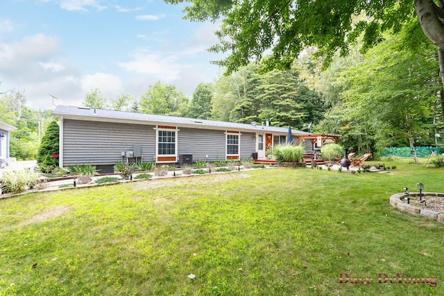 rear view of house featuring a yard