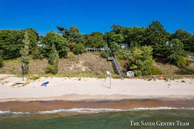 exterior space with a water view and a view of the beach