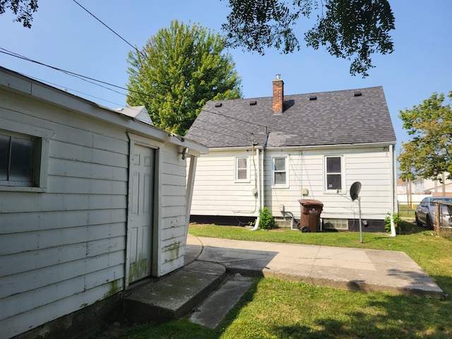 rear view of house featuring a yard