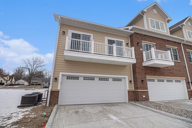 view of front of property featuring cooling unit and a garage