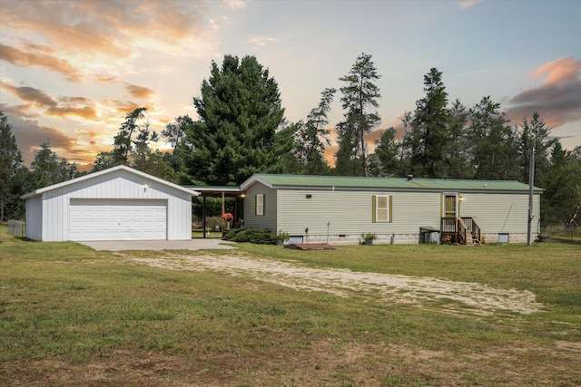 view of front of house with a garage and a lawn