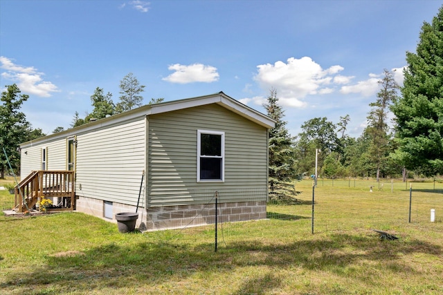 view of home's exterior with a lawn