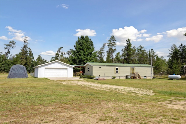 exterior space featuring a garage, an outdoor structure, and a front yard