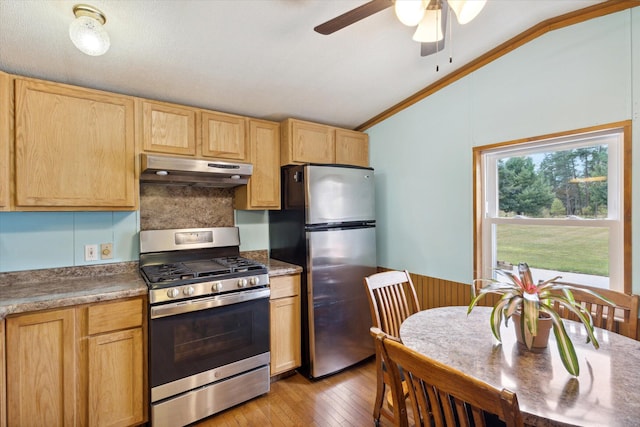 kitchen featuring lofted ceiling, light hardwood / wood-style flooring, ornamental molding, light brown cabinetry, and stainless steel appliances