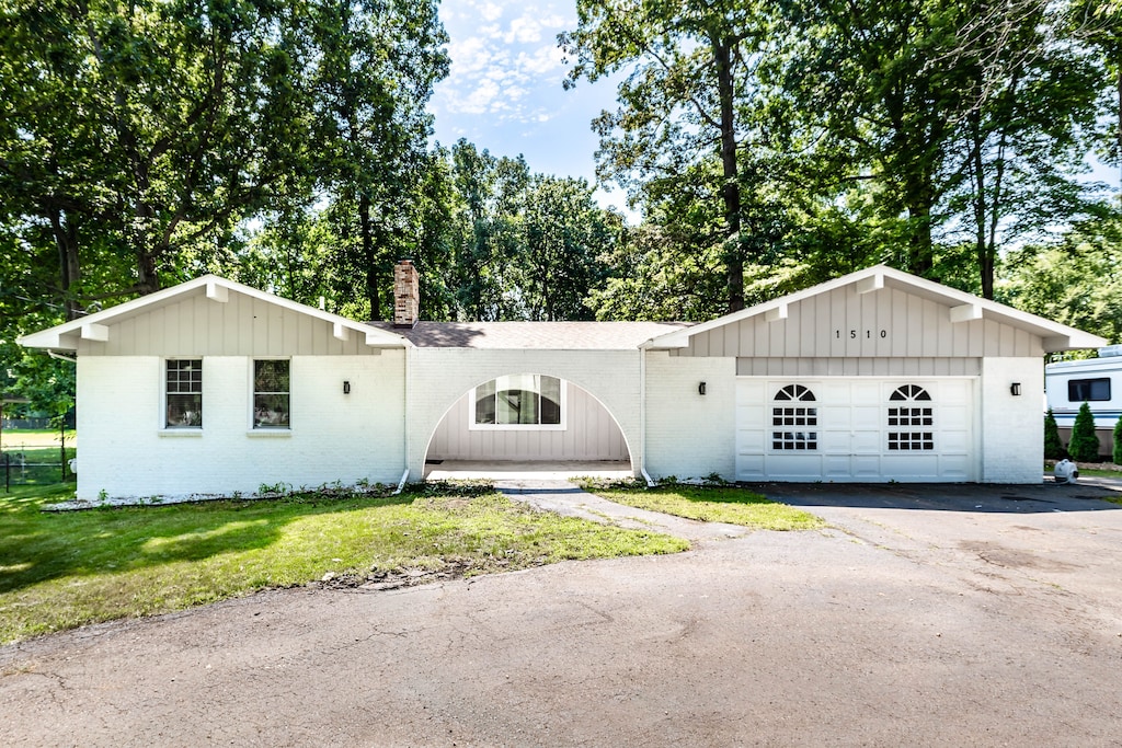 view of front of house with a front yard and a garage