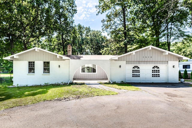 view of front of house with a front yard and a garage