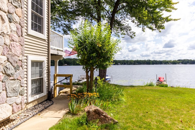 view of yard with a water view and a balcony