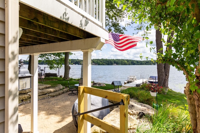 view of patio featuring a dock and a water view