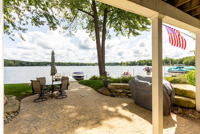 view of patio / terrace featuring a water view and a grill