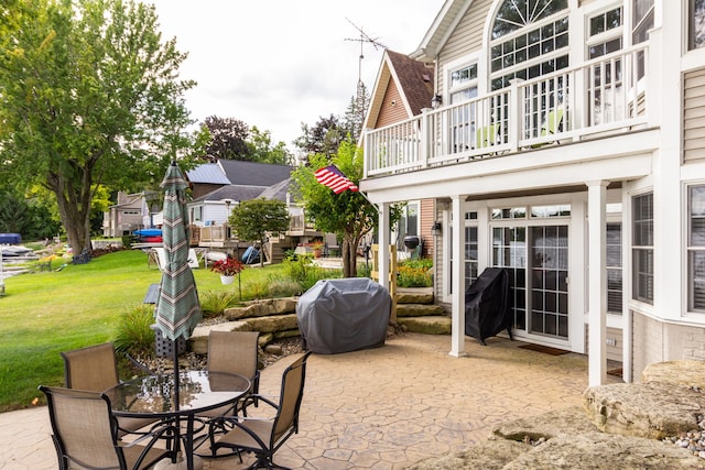 view of patio featuring a balcony and grilling area