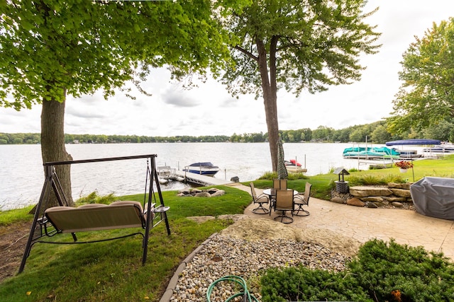 view of yard featuring a water view and a boat dock