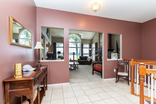 interior space featuring light colored carpet, a wealth of natural light, and lofted ceiling