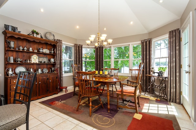 dining area with light tile patterned floors, vaulted ceiling, and an inviting chandelier