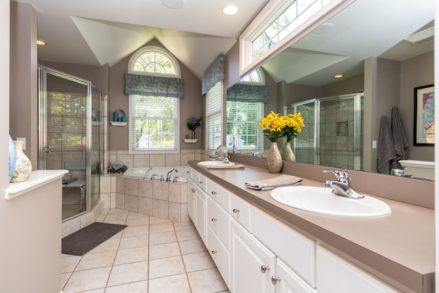 bathroom featuring tile patterned flooring, vanity, lofted ceiling, and shower with separate bathtub