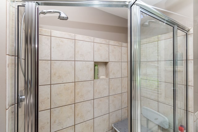 bathroom featuring a shower with door