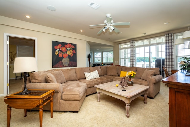 living room featuring light carpet and ceiling fan