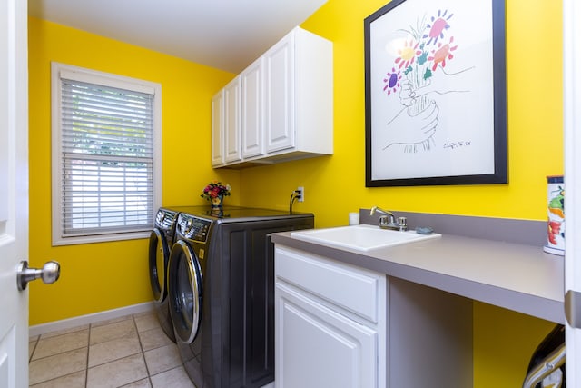 clothes washing area featuring sink, light tile patterned floors, cabinets, and independent washer and dryer