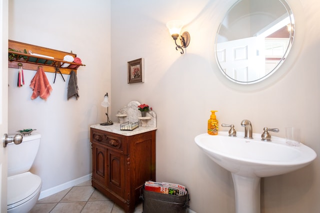 bathroom featuring tile patterned flooring, toilet, and sink