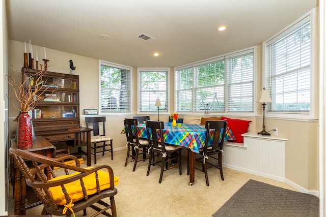 carpeted dining area with a healthy amount of sunlight